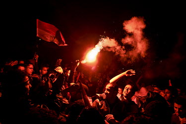 A joyous crowd is lit up by a burning flare as hundreds of thousands of people, from all over Egypt, descend into Tahrir Square to join in the celebrations at the news that Hosni Mubarak had resigned...