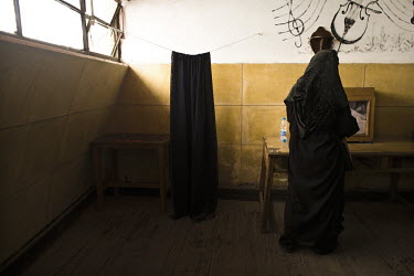A woman casts her vote in the referendum held to decide when and how a government should be formed following the resignation of President Hosni Mubarak. 25 January 2011 saw the beginning of a nationwi...
