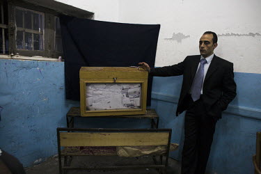 A man guards a ballot box stuffed with votes cast in the referendum held to decide when and how a government should be formed following the resignation of President Hosni Mubarak. 25 January 2011 saw...