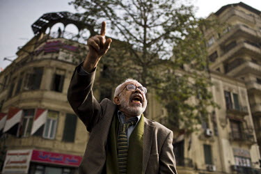 A man, part of several small groups of protesters chanting anti-government slogans and polemics, on the streets around Tahrir Square. 25 January 2011 saw the beginning of a nationwide 18 day protest m...