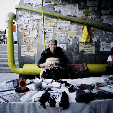 A market stall selling shoelaces and socks is set up inside a pedestrian underpass leading to Nukus central outdoor market.