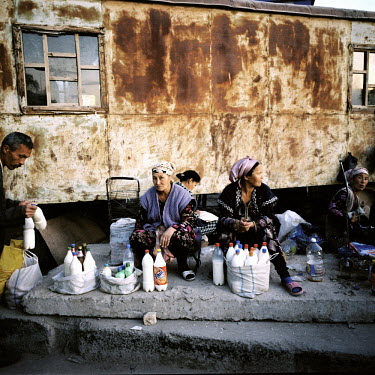 Local women sell homemade milk on the outskirts of Nukus' central outdoor market.