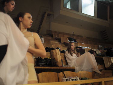 Young women wait backstage during a student's show.