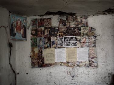 Pictures cut from fashion magazines and notices pasted on a wall at the Navagrodovskaya coal mine, West Donetsk.