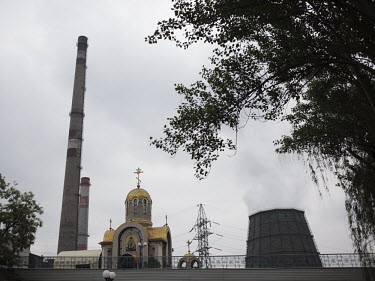 An Orthodox church stands next the chimneys at the Donetsk steel plant.