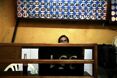 A man plays Bingo in a popular venue in old Quito. Gambling has been banned under the new Ecuadorean constitution and all such venues will eventually have to close down.