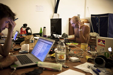 Men smoke and use computers at the Indignes media centre in Paris. The Indignant movement (Indignes, los Indignados) calls for social justice and change in it's respective countries.