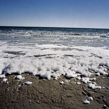 Thick white foam 100cm wide forms at the shore line of the Aral Sea. The cause of this thick solid foam is probably from the increased salinity of the sea.