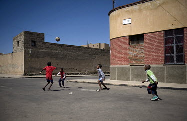 A group of young boys playing a game of football.