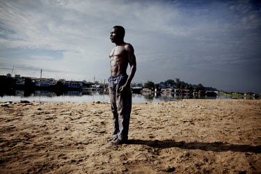 A man teaches his students taekwondoo at the beach in the township West Point in Monrovia.