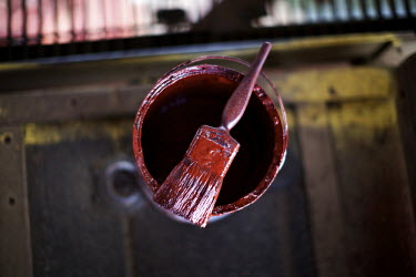 A paint pot with a hand brush used to touch up small sections the 125 year old Forth Rail Bridge which spans the river Forth near Edinburgh. Network Rail, the operator of the rail track that leads ove...
