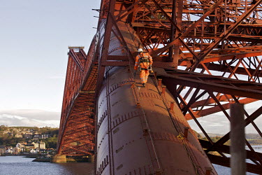 A workers climbs one of the main pipes that make up the supporting structure of the 125 year old Forth Rail Bridge which spans the river Forth near Edinburgh. Network Rail, the operator of the rail tr...