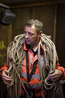 Portrait of Gordon Hunter, 43, rope access co-ordinator, as he prepares for another shift on the 125 year old Forth Rail Bridge which spans the river Forth near Edinburgh. Network Rail, the operator o...