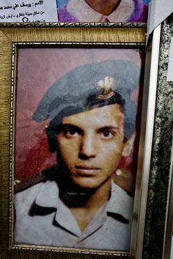 A framed photograph of a missing man in army uniform placed outside the central courthouse in Benghazi. The courthouse has become a focal point for relatives of people who have gone missing in Libya i...