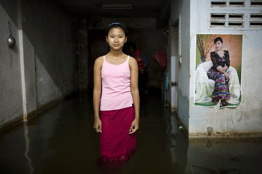 A girl stands in the doorway of her family's flooded home in central Ayuthaya, during Thailand's worst flooding for seventy years. More than 650 people have died and thousands made homeless by the flo...