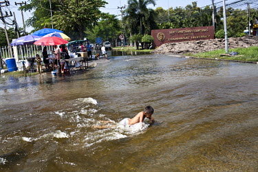 A young boy plays in flood water near Thammasat University. Large parts of central and northeastern Thailand have been severely affected by the worst flooding for seventy years. More than 650 people h...