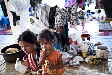 A woman and her daughter at an evacuation centre on the outskirts of Bangkok. Large parts of central and northeastern Thailand have been severely affected by the worst flooding for seventy years. More...
