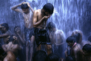 Followers of the Shiva sect of Hinduism bathe at a Hindu Bathing festival at Courtalam waterfall, Tamil Nadu, India.