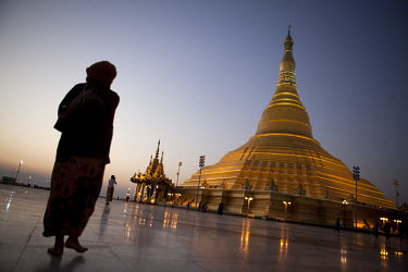 Visitors walk near the replica of the famous Shwedagon Pagoda in Naypyitaw, the new capital of Burma (Myanmar) since November 2005.