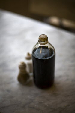 A bottle of vinegar and a salt and pepper pot on the table in F Cooke's Pie and Mash shop in Hoxton, London.