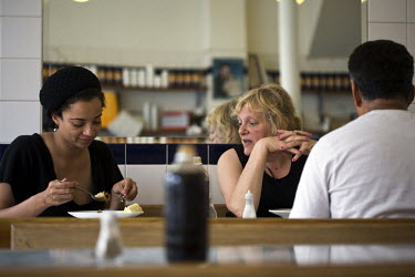 Customers eats a plate of eels, pie and mash at F Cooke's Pie and Mash shop in Hoxton, London.