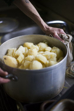 Chef Joe Cooke strains potatoes in the kitchens of F Cooke's Pie and Mash shop in Hoxton, London.