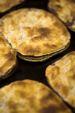 Pies fresh from the oven in the kitchens at F Cooke's Pie and Mash shop in Hoxton, London.