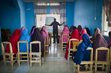 A aid worker talks to a group of women at the Elman Peace and Human Rights Centre, one of the only aid organizations in Somalia dealing directly with issues around sexual abuse. According to abused wo...