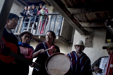 The Yambombo/Guanutaxi family play instruments at their house, watched by their daughters, during Carnival.