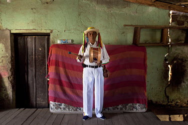 71 year old Segundo Andres Zaruma in his home dressed as Taita Carnaval during Carnival.