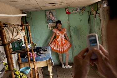Yesseina Segura (14) poses, in her Carnival outfit, for a picture at her uncle's house.