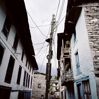 Power lines connecting to houses from a central pylon in the Bhote Koshi Valley.