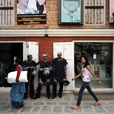 Women pass a group of policmen in central Kathmandu.