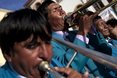 A band perform at the Carnaval de Oruro. During the fiesta many people sacrifice llamas and give offerings such as coca leaves and cigarettes to show their dedication to the Devil, a Virgin, Pachamama...
