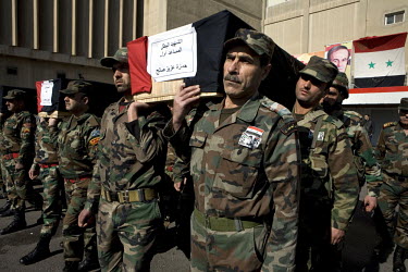 Army colleagues carry the coffin of Adjutant Marin Saleh Ahmad of the Syrian army at his funeral in Damascus. He was shot in the chest by a sniper in the eastern suburbs of the city.Protests against t...