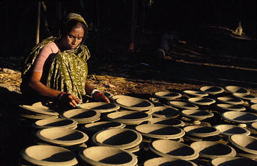 Woman polishing pots.