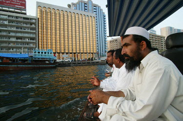 Men travel on a ferry taxi.