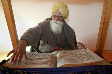 A Sikh man reads a book.