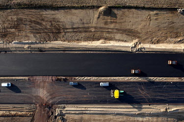 Construction vehicles on a newly laid highway.