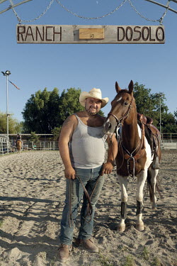 A riding school owner with one of his horses.