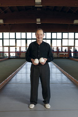 A elderly man in a Bocce hall in the small provincial town of Funo.
