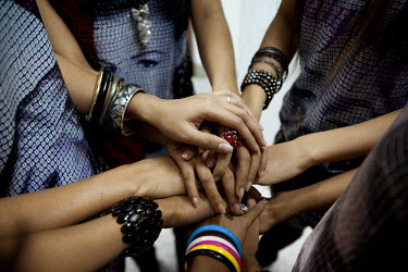 Members of 'Me N Ma Girls', Myanmar's first girl band, join hands before going on stage for a performance at a private function in a hotel in Yangon. The band's members were recruited by Australian da...