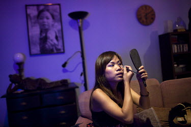 Kimmy one of the 'Me N Ma Girls', Myanmar's first girl band, applies makeup after a rehearsal before going to her evening job as a bar singer. The band's members were recruited by Australian dancer Ni...
