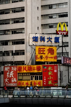 Neon advertising hordings, including one for McDonald's, written with Chinese characters on the side of a building in central Shanghai.