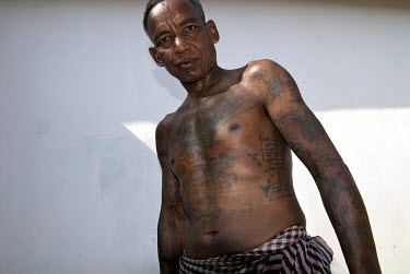A veteran of many wars in Cambodia displays the tattoos that he says kept him from death while he was fighting with Lon Nol's forces and then the Khmer People's National Liberation Front (KPNLF) again...