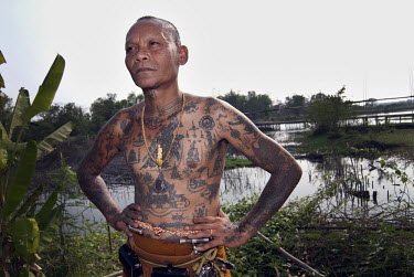 A monk shows his Sak Yan or Sacred Tattoos.