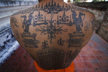 A monk at Wat Bang Phra shows his Sak Yan or Sacred Tattoos.