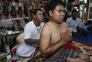 Tattoo master (khru Sak) Ajarn Montri 'activates' a new Sak Yan or Sacred Tattoo by putting his disciple (luuk sit) into a trance.