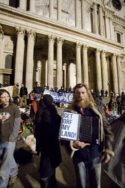 A protester at the 'Occupy London Stock Exchange' (OLSX) encampment on the small square in front of St Paul's Cathedral in London shows the screen of his computer which reads 'Get Orf My Land'. The en...