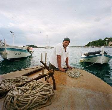 A fisherman on his boat in the port of Hvar, the main town on the island of the same name.